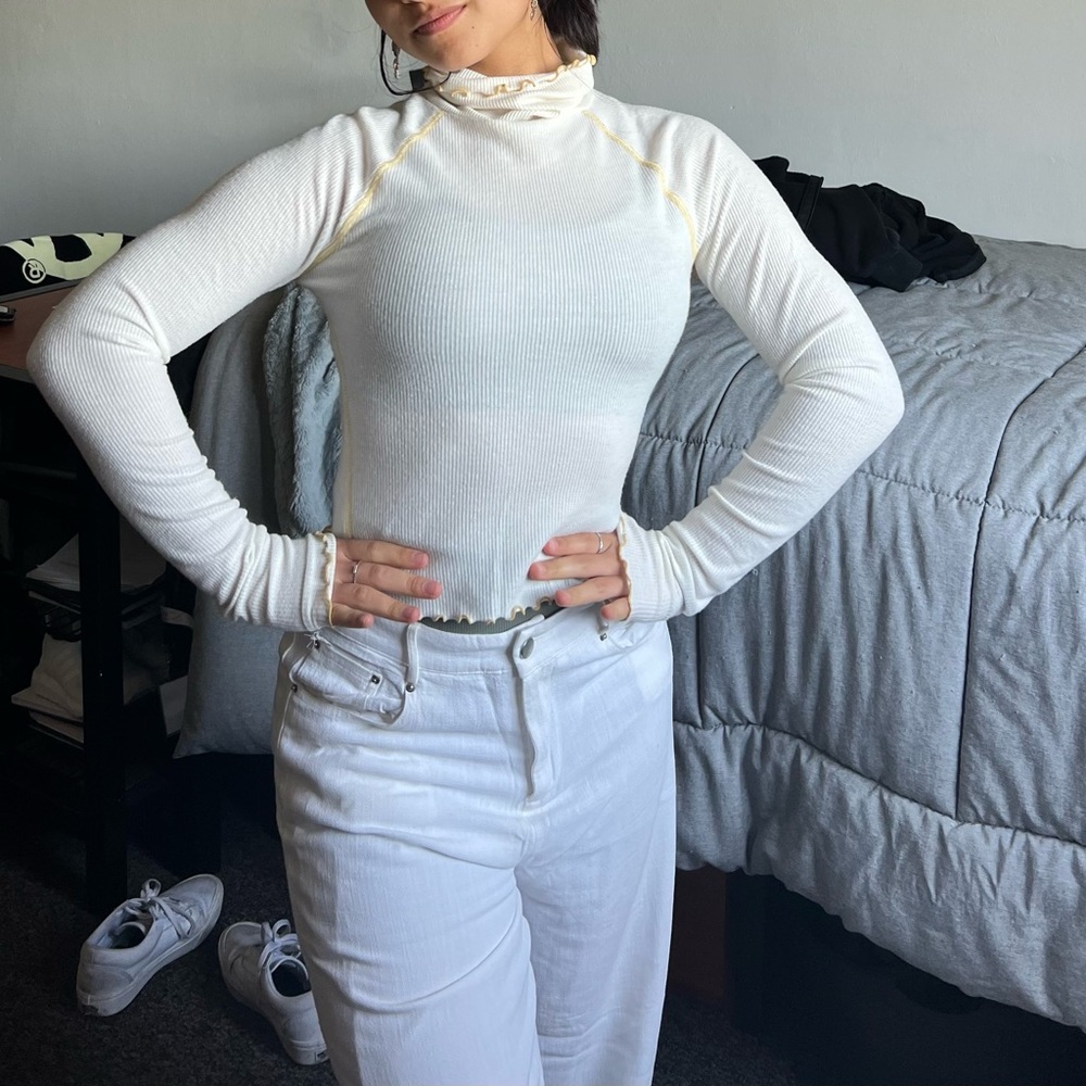 Beige long sleeve turtleneck. It is thin, but not see through.